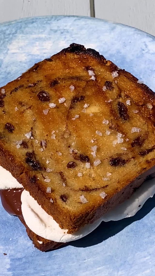 Here’s how to make @itsalislagle’s Grilled S’mores Sandwiches:

• 8 slices cinnamon swirl bread (with or without raisins)
• Mayonnaise
• 4 ounces bittersweet or semisweet chocolate bars, broken into roughly 1-ounce pieces
• 8 marshmallows, torn in half
• Flaky or kosher salt

Prepare a charcoal or gas grill for medium-low heat. (Medium-low is between 250 and 325 degrees. You should be able to hold your hand 4 to 5 inches above the grates for 8 to 10 seconds).

Thinly spread one side of each piece of bread with mayonnaise. When you’re ready to grill, take the bread, chocolate, marshmallows, salt and a spatula to the grill. Clean the grates with a grill brush. (No need to grease the grates.) Place the bread slices on the grill mayo-side-down. In the center of half the slices, add 1 ounce chocolate to each. To the other half, add the marshmallows. Cover and cook until the bread is toasted, the chocolate is starting to melt, and the marshmallows are swelling, 4 to 6 minutes. Check on the bread often, moving slices around the grill as needed to prevent burning. If the chocolate is melted before the bread is crisp, increase the heat to medium.

Use the spatula or your hands to flip the marshmallow slices onto the chocolate slices. Transfer to plates, press down slightly to meld (chocolate and marshmallow will ooze out), and sprinkle with salt. Eat it as fast as you can.