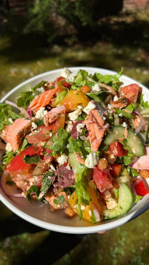 Salmon Chopped Salad 

Recipe:
Roasted garbanzo beans:
1 (15-ounce) can garbanzo beans, rinsed
2 tsp olive oil
1/2 tsp salt
1/4 tsp pepper
1/2 tsp garlic powder 
1/2 tsp paprika 
-Preheat oven to 375°F.
-Drain and pat garbanzo beans. Add to a sheet pan and cover with olive oil and seasonings. 
-Bake for 25-30 minutes, shaking halfway through. Set aside.

Salmon:
1.5 lbs salmon fillet
2 tbsp olive oil
1/2 a lemon, juiced
1 tsp dried dill
1 tsp dried oregano
1/2 tsp garlic powder
1/2 tsp salt
1/4 tsp pepper 
-Add olive oil, lemon juice, and all seasonings to a bowl. Mix to combine. Place salmon on a sheet pan and cover with the seasoning mixture. 
-Bake in the preheated oven at  375°F for 12 minutes, until cooked through and flakey. 

Salad ingredients:
1 head escarole, chopped
1/2 a red onion, sliced
1/2 cup parsley, chopped
1/4 cup mint leaves
1/2 cup kalamata olives, pitted and cut in half
feta cheese crumbles
2 large heirloom tomatoes, chopped into chunks
1 cucumber, seeded and chopped into chunks
1 tsp salt
-Chop and prepare all ingredients. Add tomatoes and cucumber to a large strainer and toss with salt. Let drain while you prepare the rest of your meal, at least 10 minutes. This will get rid of the excess juices. 

Salad dressing:
1/4 cup red wine vinegar
2 garlic cloves, minced
3 Tbsp olive oil
1 tsp Dijon mustard
1 tsp honey 
1/2 tsp salt 
1/4 tsp black pepper 
-In a large bowl, whisk together salad dressing ingredients. Add all vegetables, garbanzo beans, feta, and salmon. Mix and enjoy!

#food

#food #easyrecipe #foodies #salad #salmon
