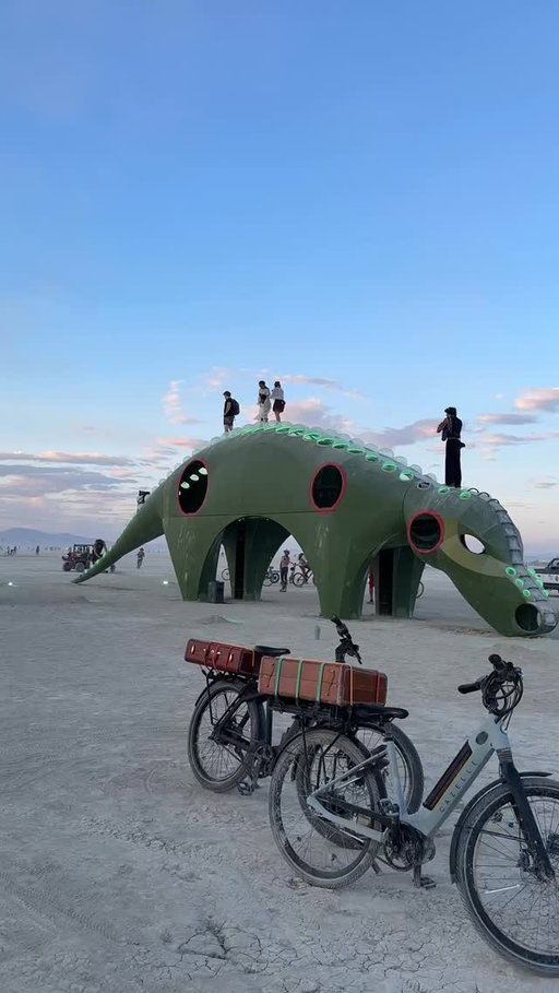Sunset in Black Rock City casts its golden light across the playa, touching those who wander, climb, dance, or simply sit with their campmates in stillness.

Tonight the Man burns, a reminder of all you’ve endured and created through a challenging week. Burning Man is not a festival — it is a global cultural movement that brings people together to connect and create in so many imaginative ways. Weather shifts, unpredictability rises, yet this community thrives because of you. It isn’t built or returned to dust by spectators, but strengthened through Communal Effort and Participation, each citizen shaping its spirit together.

Art piece 1: “Guma” by Harper Clark
Art piece 2: “Mycelia” by Daniel Popper
Art piece 3: “Out the Other” by Kate Greenberg
Man Pavilion designed by Mark Rivera (Kidnetick)