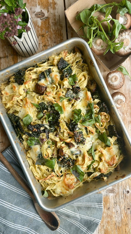 Creamy Roast Mushroom & Garlic Tagliatelle Bake

#recipe ⬇️ 

The sun seems to be a little shy this week and I want cosy, quick and comforting food and for me, that is always pasta. Pasta is such a treat for us which seems ridiculous because it’s such a basic staple but for some reason we don’t eat a lot of it at home. 

Simple, all in one (except for the bit that gets whizzed up) and wonderfully tasty, it really is the cosy comfort food of pasta perfection.

•	400g chestnut mushrooms – roughly chopped
•	1 bulb of garlic – sliced in half across the middle
•	1 tablespoon rosemary leaves
•	½ white onion – cut into wedges
•	Olive oil
•	Salt and pepper
•	A splash of white wine (can be replaced with water)
•	Fresh basil
•	200ml cream
•	2 tablespoons Greek yoghurt
•	100g fresh parmesan – finely grated
•	100g fresh mozzarella ball - torn
•	500g Fresh tagliatelle 
•	100g cavolo nero – chopped
•	75g frozen peas

You will need a large oven-proof roasting tin. Pre-heat the oven to 190°C (170ºC fan/375°F/Gas 5) 

Place the mushrooms, garlic bulb and onion wedges into the roasting tin.  Season with salt and pepper and sprinkle well with rosemary leaves.  Drizzle with olive oil and a slash of white wine (or water) and mix well.  Roast for 20 minutes or until the garlic is soft and tender and the mushrooms and onions are cooked.

Remove from the oven and allow to cool slightly whilst you cook your fresh pasta as per the packet instructions. I added the cavolo nero here too.  Drain well reserving a cup-full of the pasta water.

Spoon out half the roasted vegetables into a food processor and squeeze the garlic in too.  Add the Greek yoghurt, grated parmesan, half the pasta water and fresh basil and whizz until smooth.

Pour the sauce back into the roasting tray along with the cream, the pasta and the frozen peas and stir well, adding a little more pasta water if it needs lubricating.  Tear over some fresh mozzarella and pop it back into the oven for 5 – 8 minutes to get bubbly and golden.  Serve with freshly torn basil.

#pasta #pastabake #mushrooms #onepot #cheese