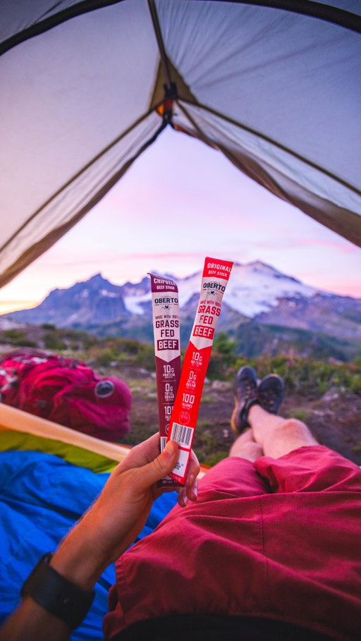 That feeling of getting to your campsite and sitting down for a well-deserved snack! 
@obertobeefjerky has become my new favorite for snacks like this. Made with 100% Grass Fed Beef, these meat sticks contain 10g of protein per stick for only 100 calories. They have zero sugar and no artificial ingredients so I honestly would 10/10 recommend them for your next hike. 
#ObertoGrassFed #ObertoAmbassador #sponsored