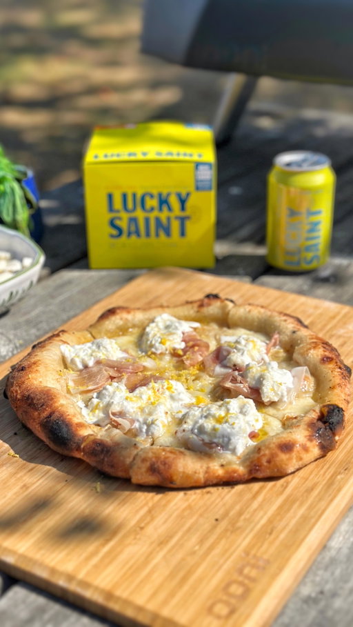 Pizza and beer, a match made in heaven! The perfect match just got even better though! Lucky Saint have partnered with Ooni to give you the chance to win a brand spanking new Koda 2 pizza oven when you buy one of their 4-packs in Tesco. 
( Check my link in bio on how to enter)

I’ve been loving Lucky Saint’s alcohol free Lemon Lager all summer long, and to celebrate this giveaway I wondered what would happen if I added a can of it to my pizza dough! Turns out it works an absolute treat, creating a fantastic dough with an extra hint of lovely beer and lemon! You already know what pizza I’m going to pair it with too right? Yes, the old Lemon Aid pizza is getting an upgrade! So today I present to you, The Lucky Saint Lemon Fest pizza! Recipe below, makes 3 x 280g doughballs, ready in 8 hours.
·         500g Pizza Flour
·         1 x 330ml can of Lucky Saint Lemon Lager
·         2.2g Fresh yeast or 1g dried yeast
·         15g Fine Sea salt
 
Mix your ingredients together, (hand mix or use a mixer) let it rest in a covered container in bulk for 2 hours, then ball up and cover at room temperature for another 6 hours. This is a perfect recipe to make when you get up in the morning, and you’ll be ready to make fresh, delicious pizza by the evening! Open out your dough ball, add a swirl of olive oil, a handful of grated grana padano, and 100g of chopped mozzarella. Bake in your pizza oven for 90 secs, remove from the oven, slice the pizza into 6 and then on each slice add some Parma ham, then burst a ball of burrata over the whole pizza and distribute evenly. The final flourish? Grate some fresh lemon zest on top and then a drizzle of white truffle honey. Seriously, on its own, it’s delicious, but pair it with an ice cold can of lemon lager and you are in heaven!
 
Enjoy!
 
Here’s the legal stuff  https://www.tesco.com/groceries/en-GB/zone/541589-Lucky-Saint-TTW?icid=DHNotAnotherBeerCoLtdLuckySaintCompTTWSBP7TW25_ad541589

#doughandbehold #luckysaintbeer #pizzaandbeer #pizza #ad #alcoholfree #giveaway #foodie #pizzalover