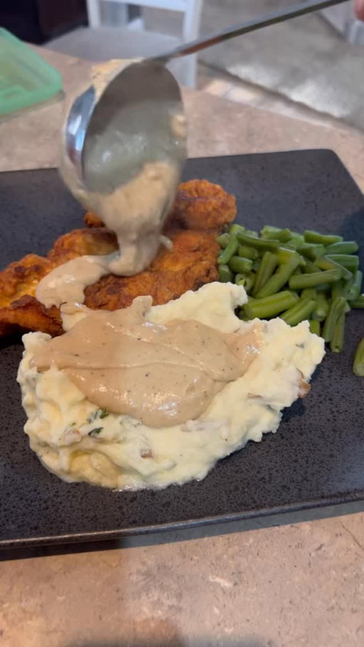 Pan Fried Chicken and Gravy
Chicken

4 chicken breasts
1 cup flour
2 tbsps each of garlic powder, onion powder
1 tbsp paprika and creole seasoning 
Salt and pepper too taste
1-2 eggs
Oil for frying 

Gravy
1 tbsp drippings strained
3/4 stick butter
1/2 cup flour
2 cups milk
Salt, pepper, garlic too taste
1/2 cup of chicken stock and use to thin out
Parsley too garnish 

Steps

Chicken 

Preheat Cast iron skillet with just enough oil to cover to middle of chicken (1/2-1 inch)

Press out chicken breasts thin or slice flat, coat in flour and seasonings

Place in egg wash and coat evenly, then toss back in flour for an additional coat 

Let rest on a plate while oil heats up to 325

Once oil is to temp gently place chicken into pan laying away from you

Fry til golden on both sides and temp is at 165

Remove from oil and place on paper towel to catch excess oil 

Gravy 

Strain and remove oil from pan, saving 1 tbsp minimum of drippings, melt butter in pan 

Once butter is melted toss in flour and stir in til incorporated letting cook for a couple mins to remove flour taste

Whisk in milk slowly scraping bottom of pan to make sure roux doesn’t burn

Add all seasonings and chicken stock, stir until desired consistency. If too thick add more chicken stock

Serve hot, i garnish with a little parsley too brighten up the plate