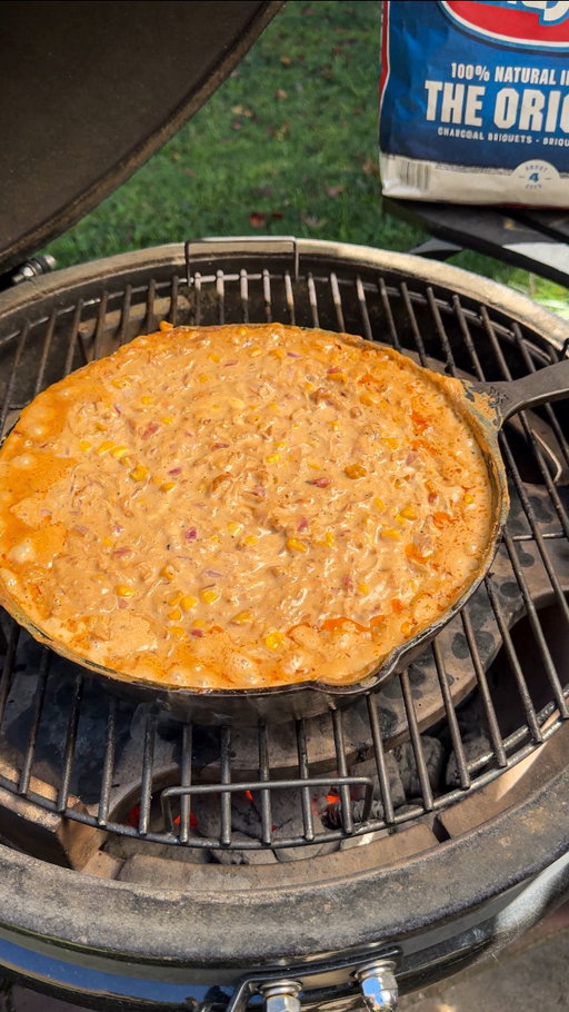 Move over buffalo chicken dip, BBQ Chicken Dip is the appetizer you need this Game Day season! Recipe ⤵️

* Fire the grill up to high heat using @kingsford briquettes
* Season 2 chicken breasts with your favorite bbq rub, grilling over high heat until done
* Remove the chicken and shredded it 
* Into a cast iron pan (or foil pan) add: shredded chicken, 8oz cream cheese, 8oz cheddar cheese, 8oz mozzarella, 1 cup diced red onions, 1 cup drained corn, 1 cup sour cream, 1 ranch packet, 1 cup BBQ sauce (optionally add 1/2 cup milk)
* Mix everything thoroughly, placing it back on the grill at 350°
* Stir every 15 minutes till the cheese melts and is nice and bubbly, then remove
* Garnish with ranch, bbq sauce and green onions
* Enjoy!