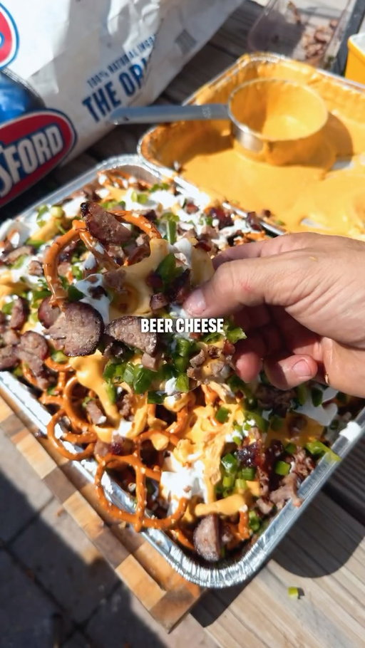 Beer cheese pretzel nachos 🤯

- Grill your brats
- Mix 8oz sharp cheddar, 8oz white cheddar, one block cream cheese, 2tsp worcestershire, 2tbs mustard, 12oz of beer and BBQ rub
- Place on indirect heat at 350
- Stir after 30 minutes then grill for 15 more
- Top pretzels with beer cheese green onion, sour cream, jalapeño, and brats