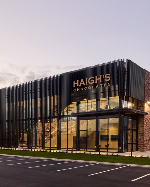 We’re proud to share an exciting new chapter in the Haigh's Chocolates story.

Our new $120 million, state-of-the-art production, warehouse and online fulfilment facility in Salisbury South, South Australia has officially opened.

Built to support our ongoing growth and commitment to delighting chocolate lovers across the country, the 18,000m² site will increase our production capacity from 1,100 to 2,000 tonnes of chocolate per year. It also features 1,180 solar panels, 1.7km of chocolate delivery pipes, and over 5km of storage space – all designed to keep our artisan chocolate making thriving for generations to come.

This is just the beginning of a delicious future. Thank you for being part of the journey. 💛