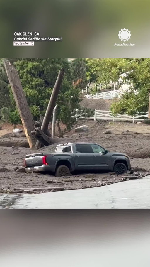 A driver tried to outrun a surge of muddy floodwater in Oak Glen, California, but the powerful current had other plans. No injuries were reported.
