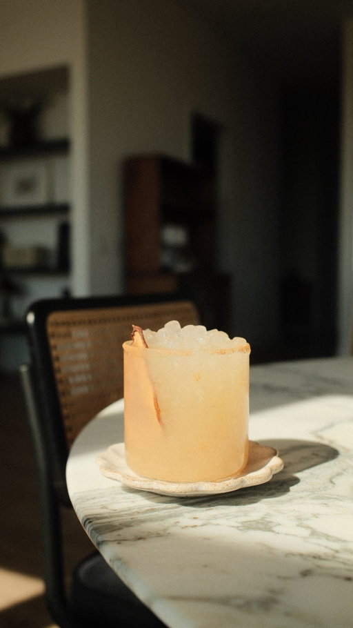 For the first day of Fall: Spiced Pear Mockarita 🍐 

𝐰𝐡𝐚𝐭 𝐲𝐨𝐮’𝐥𝐥 𝐧𝐞𝐞𝐝: ⁣
• 1.5oz of @tomonotomoagave NA tequila 
• 1 oz of @lyresspiritco orange liqueur 
• 3/4 oz of homemade spiced pear syrup (recipe below) 
• 1/2 lime, juiced 
• 2 oz of @rwknudsen pear juice 
• ice
• optional: rum glass with agave and sugar + cinnamon mixture. garnished with dried pear slice. 

Yields — 1 serving.
⁣
𝐬𝐩𝐢𝐜𝐞𝐝 𝐩𝐞𝐚𝐫 𝐬𝐲𝐫𝐮𝐩: ⁣
• Thoroughly wash 3 pears, roughly chop all, and set aside. 
• In a mortar and pestle combine: 1 whole cinnamon stick, 2 whole star anise, 8 whole allspice, 6 cardamom pods, and 12 whole black peppercorns. 
• Muddle all and set aside. 
• In a saucepan, over medium to high heat, combine equal parts water and cane sugar (1:1 cups.)
• Stir vigorously until sugar is combined. 
• Once combined, add in chopped pears + all ground spices. 
• Allow to simmer over low heat for 15-17 minutes. 
• Remove from heat and allow to completely cool in the pan. 
• Double strain into airtight container. 
• Store in the refrigerator for up to 2 weeks. 
⁣
𝐨𝐭𝐡𝐞𝐫 𝐩𝐨𝐬𝐭 𝐝𝐞𝐭𝐚𝐢𝐥𝐬: 
• Rings from @filosophy.co 
• Cutting board from @momi_vintage 
• Cocktail shaker details under: “links to all things!”
• All knives from: @shuncutlery 

enjoy 🫶🏽
#zeroproof #zeroproofcocktail #latinheritagemonth #hispanicheritagemonth #firstdayoffall #fallrecipes #spicedpear #homemadesyrup #mocktails #mocktailrecipe