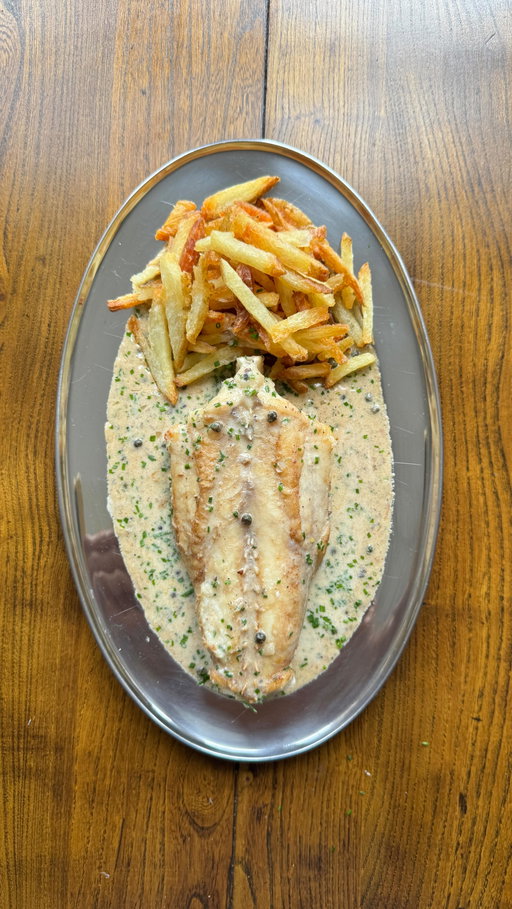 Monkfish au poivre aka the gateway dish for anyone who “doesn’t like fish.” Because monkfish is so meaty, it stands up beautifully to bold flavours like a well-loved peppercorn sauce. This one’s loaded with green peppercorns and capers for salty pops of flav, and yes, my crispy fries on the side are non-negotiable. Steak au poivre could never.

For 4
500g floury potatoes (Maris Piper works)
100ml neutral oil
Sea salt
1 monkfish tail, about 500g, trimmed, this one was kindly sent to me by @therockfishuk and was super meaty, tasty and fresh 
2 tbsp olive oil
2 tbsp butter
1 shallot, finely chopped
1 tbsp coarsely ground black peppercorns
1 tbsp green peppercorns in brine, drained
1 tbsp capers, drained
75ml brandy (or white wine if you prefer)
200ml fish stock
3 tbsp creme fraiche 
2 tbsp chives, finely chopped

1. Heat your oven to 200°C fan. Cut the potatoes into fries, soak in iced water for 30 mins. Drain, then boil in salted water for 5 mins. Drain again and air dry.
2. Pour neutral oil onto a baking tray, heat in oven till super hot, then add fries. Roast 30–35 mins until golden and crisp, turning halfway.
3. Pat monkfish dry, season with salt. Heat 1 tbsp butter + 1 tbsp oil in an ovenproof pan, sear monkfish 5 mins per side until golden. Transfer to oven and roast 20-25 mins until firm and opaque. Rest on a warm plate, covered in foil.
4. In the same pan, add remaining butter + oil, then shallot and black pepper. Cook 4 mins. Deglaze with brandy, bubble 1 min, then add stock and educe 5 mins.
5. Stir in the green peppercorns, capers, crème fraîche, and chives. Simmer until thick and glossy. Taste and season.
6. Spoon sauce onto a platter, place monkfish on top, and serve with fries on the side.