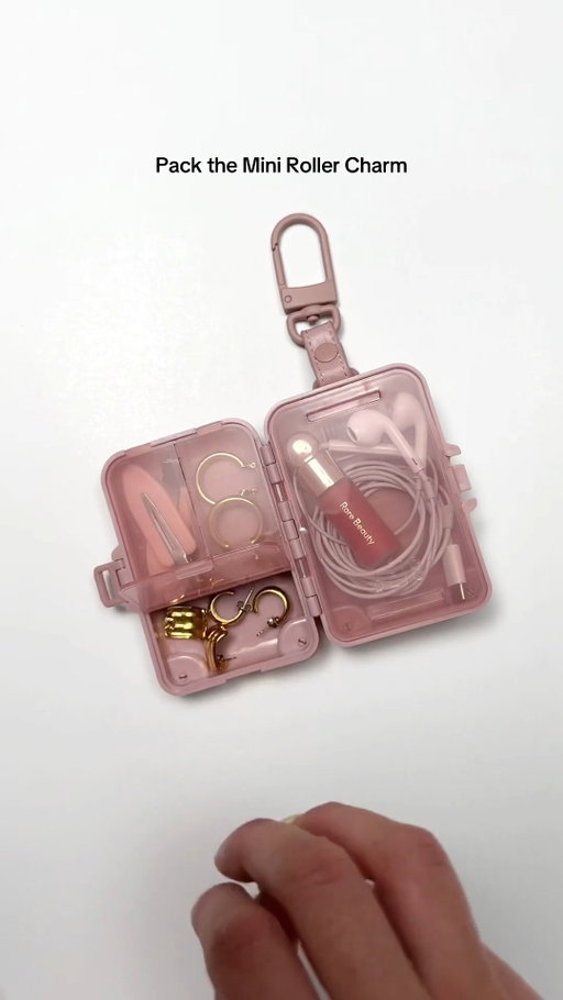 This one's going to fit in every single overhead bin. Shop the Mini Roller Charm in Atlas Pink, Maple, Black and Beige.