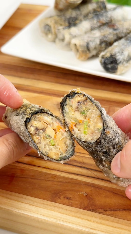 Crispy Rice Paper Seaweed Rolls

Filling:
4 oz. vermicelli noodles
Hot water, to rehydrate noodles
10 oz. shrimp, peeled and deveined
2 scallions, chopped
1/2 carrot, shredded
2 dried shiitake mushrooms, rehydrated and diced
2 Tbsp soy sauce
1 Tbsp oyster sauce
1 tsp sesame oil
1/4 tsp salt

Dipping Sauce:
3 Tbsp soy sauce
1 Tbsp oyster sauce
1 1/2 tsp sugar
1 Tbsp water
1 tsp sesame seeds

Rolls:
12 sheets rice paper
6 sheets roasted seaweed nori, cut in half
Oil, for frying
1. Make the filling: Soak the vermicelli noodles in hot water (just enough to cover) for about 5 minutes, or until softened. Drain well, then snip into smaller pieces with kitchen scissors.
2. Place the shrimp in a food processor, and pulse until it forms a smooth paste. Alternatively, you can finely mince it with a knife until paste-like.
3. In a medium bowl, mix together the chopped noodles, shrimp paste, scallions, carrot, mushrooms, soy sauce, oyster sauce, sesame oil, and salt until everything is well combined.
4. Make the dipping sauce: Whisk together the soy sauce, oyster sauce, sugar, water, and sesame seeds in a bowl. Set aside.
5. Make the rolls: Fill a large shallow plate with lukewarm water. Dip one sheet of rice paper for 5–10 seconds, just until pliable, then place it on a clean surface. Lay half a sheet of roasted nori in the center, then spoon about 2 tablespoons of filling horizontally like a log. Fold the bottom edge up, tuck in the sides, and roll up tightly. Repeat with the remaining filling and wrappers.
6. Heat about 1 inch of oil in a large skillet over medium heat. Fry the rolls in batches, being careful not to overcrowd the pan, for 3–5 minutes, turning occasionally, until all sides are golden and crispy.
7. Remove from the oil, drain briefly on a wire rack, and enjoy immediately.