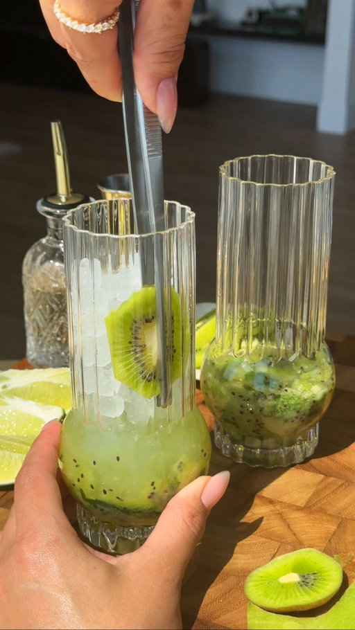 Kiwi Ginger & Coconut No-Jito 🥝 

𝐅𝐮𝐥𝐥 𝐫𝐞𝐜𝐢𝐩𝐞:⁣⁣
· 1 kiwi, roughly chopped
· 1/2 lime, squeezed 
· 1/2 tbsp of raw sugar 
· Handful of mint leaves 
· Ginger root, grated — desired amount 
• 1.5 oz of NA white rum
· 3 oz of @harmlessharvest coconut water 
· Ice 
· Splash of @topochicousa sparkling water 
· Garnish with mint sprig 
· Optional: rim glass with agave, coarse salt, & lime zest.

Note — serves 2.
⁣⁣
𝐌𝐞𝐭𝐡𝐨𝐝: 
· Roughly chop one kiwi.
· Add 1/2 tbsp of raw sugar (or any type of sweetener.)
· Add a handful of mint leaves.
· Grate desired amount of ginger root (this step is optional, but I love the added gut-health benefits.) 
· Squeeze 1/2 a lime (roughly 1/2 oz.) 
· Muddle to blend flavors.
· Add 1.5-2 oz of NA white rum and 3 oz of desired coconut water (for added electrolytes.) 
· Add ice.
· Shake & strainer over 2 glasses.
· Top off with sparkling mineral water. 
· Optional: Garnish with mint sprig. 

𝐎𝐭𝐡𝐞𝐫 𝐝𝐞𝐭𝐚𝐢𝐥𝐬: 
· Glassware linked under: “glassware collection.” 
· Strainer + ice scoop & silicone brush linked under: “cocktail bar essentials.” 
· Rings from: @bldxmonique 
· Marble tray from: @mezcalforlife 
· Wood spoon from: @casa.evita 

Enjoy 🫶🏽

#summercocktails #mocktails #cucumber #mojito #sobercurious #coconutwater
