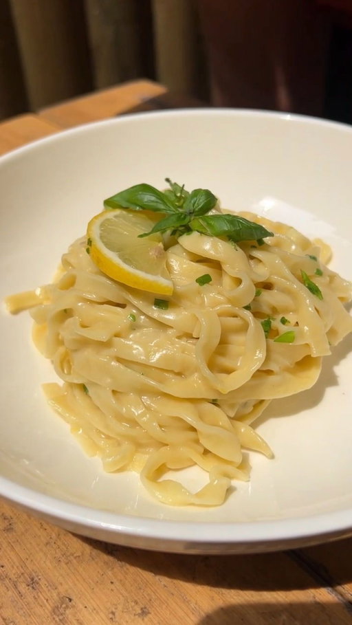Minimal ingredients, maximum flavor🍋🧈 Hand-cut pasta or pantry dry: this lemon butter herb sauce makes it special either way😋 Basil, mint, cheese, done🌿🧀 You’ll fall in love with this recipe @chefmarco_nyc @giallolovesitaly

Ingredients (serving 3):
Pasta: 500g if fresh, 400 if dry
Butter: 150g
1 lemon (Zest and juice)
Mint to taste
Basil to taste
Salt to taste

Pasta making:
Mix 1 egg every 100g of flour, 00 is the best choice but all porpoise works too. Slowly incorporate the flour to the eggs using a bowl or the classic vulcano shape (as shown in video). Knead the dough until smooth and uniform (about 7mins) then let it rest for a minimum of 30mins. Roll the dough using either a pasta machine or a Rolling pin. The first is faster and easier, the rolling ping ensure a rougher texture, better for holding this simple sauce.

Sauce:
Heat up the butter and cook the shallots in it for 4/5 mins or until they’re translucent. Add lemon zest and reduce the heat. Quickly cook pasta in the salted boiling water and finish cooking in the sauce pan. Once water evaporates finish the dish with more lemon zest, a mix of your favorite herbs and cheese.

#giallolovesitaly #gz #pasta #lemon #italianfood #yummy