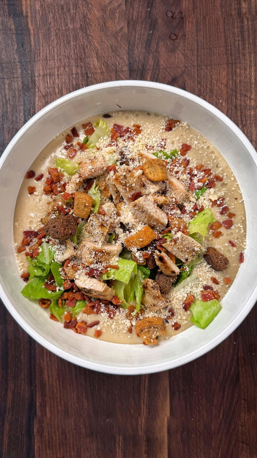 Chicken Caesar Salad Soup. Smash 👍🏻 or Pass 👎🏻

RECIPE
1 pound of chopped bacon
1 diced onion
5 cloves of garlic
1 large russet potato 
4 cups chicken stock
2 cups heavy cream
1/4 cup chopped anchovies
1/2 cup grated parmesan cheese
Juice of a lemon
1 cup chopped romaine lettuce
1 cup croutons
4 large chicken tenders
1 tbsp garlic powder

Fry the bacon in a large soup pot, then extract the bacon and leave the grease.
Add the onions garlic and potatoes and saute for about 5 minutes just until the onions are softened 
Add the chicken stock and season with a generous amount of salt and pepper
Simmer for about 10 minutes
Chop up the anchovies, and grated the parmesan cheese
Add it to the soup and using a hand blender or regular blender, puree the soup until its a smooth consistency
Stir in the heavy cream and lemon juice
Season the chicken with salt, pepper, and garlic powder and grill on both sides for about 3 minutes aside. Then chop it up
Add the soup base to a bowl, place the lettuce on top, followed by the croutons, chicken, chopped bacon and some more parmesan cheese. Hit it with some lemon juice and enjoy