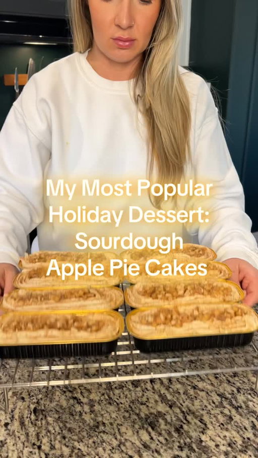 These Sourdough Apple Pie Cakes are my ultimate holiday party flex 🍏✨. They’re the dessert I always bring because everyone loves them, raves about them, and yes… strokes my ego a little 😏. Soft sourdough cake base baked with gooey apple pie filling inside, topped with cinnamon cream cheese icing and even more apple pie filling. Save this for your fall and holiday bakes—you’ll thank me later!

🍏 Sourdough Apple Pie Cakes

Base Batter
	•	1 stick (113 g) unsalted butter, melted
	•	110 g active sourdough starter
	•	1 large egg
	•	180 g sour cream
	•	5 g vanilla extract
	•	200 g all-purpose flour
	•	200 g raw cane sugar
	•	10 g baking powder
	•	3 g baking soda

Apple Pie Filling (make full batch; use ⅔ inside, ⅓ on top)
	•	400 g diced apples (about 4 medium)
	•	60 g (¼ cup) butter
	•	100 g (½ cup) brown sugar
	•	2 tsp cinnamon
	•	½ tsp nutmeg
	•	1 tbsp flour 

Cream Cheese Cinnamon Icing
	•	115 g (4 oz) cream cheese, room temp
	•	60 g (¼ cup) unsalted butter, room temp
	•	80 g (⅓ cup) brown sugar
	•	60 ml (¼ cup) whole milk (or cream)
	•	1 tsp vanilla extract
	•	1 tsp ground cinnamon
	•	Pinch of salt

Instructions
	1.	Cook the apple filling – Melt butter in skillet. Add diced apples, cook 2 min. Stir in brown sugar, cinnamon, nutmeg, and salt. Cook until tender + glossy (about 5 min). Then add flour and cook until it thickens (about 3 minutes). Let cool slightly.
	2.	Make the batter – Whisk melted butter + starter until smooth. Add egg, sour cream, and vanilla. Mix well.
	•	Sprinkle in flour, sugar, baking powder, and baking soda one at a time, folding after each.
	•	Fold in ⅔ of the apple filling.
	3.	Bake – Divide into 12 tulip liners. Bake at 400 °F for 15-20 minutes, checking at 18. Done at 195 °F internal temp.
	4.	Icing – In a saucepan, whisk brown sugar, milk, and salt. Cook until sugar dissolves and slightly thickens, add vanilla immediately. Cool completely. Beat with cream cheese, cinnamon + butter until smooth.. Chill 20-30 min to thicken.
	5.	Finish –  Pipe on cream cheese icing, top with remaining apple pie filling, then graham cracker crumbs and cinnamon.