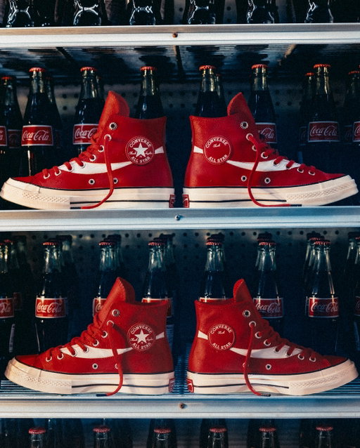 The limited-edition Converse x Coca-Cola Chuck 70, featuring luxe red leather, Georgia green soles, and bottle cap eyelets just dropped on Converse.com.