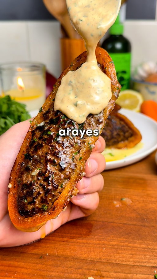 Arayes 🔥 

You can find this recipe and all of my recipes on my free app. Search “Osta Recipes” on the App Store or Google Play store ‼️

Comment “Recipe” and I’ll send you the full recipe card for free!!

Crispy, Juicy Middle Eastern Meat-Stuffed Pitas with a Garlic Tahini Sauce 🥙

Ingredients:
-4 small pitas, cut in half
-1 yellow onion, grated & squeezed dry
-7 garlic cloves, minced
-2 tbsp tomato paste
-1/3 cup fresh parsley, chopped
-1/3 cup fresh cilantro, chopped (optional but excellent)
-1 tbsp olive oil
-1 lb (0.45 kg) lean ground beef
-Spices: 1 tsp salt, 1 tsp black pepper, 1 tsp cinnamon, 2 tsp cumin, 2 tsp paprika, 1 tsp allspice

For the Garlic Tahini Sauce:
-1/2 cup Greek yogurt
-3 tbsp tahini
-1/2 lemon, juiced
-2 garlic cloves, minced
-2 tbsp olive oil
-1/4 cup fresh parsley, chopped
-1/4 cup fresh cilantro, chopped
-1 tsp each: cumin, salt, pepper, paprika

Instructions:
1. Preheat your oven to 350°F (175°C). Grate your onion and squeeze every last drop of liquid out using paper towel or cheesecloth. 
2. In a large bowl, combine the ground beef, tomato paste, minced garlic, all the spices, parsley, cilantro (if using), and that very dry grated onion. Mix with your hands for about 2 minutes.
3. Cut each pita in half. If they don’t already have a pocket, carefully use a knife to make one. Now, pack them with your beef mixture — and I mean stuff them. You want them full but not bursting (ripped pita = heartbreak).
4. Crisp ’Em Up: Brush the outsides of the stuffed pitas lightly with olive oil. Heat a lightly oiled skillet over medium heat. Place each arayes meat-side down and sear for 1–2 minutes until you get that gorgeous crust. Then sear the pita sides until golden and crisp. 
5. Transfer the seared arayes to a baking sheet and finish them in the oven for 10–15 minutes, until fully cooked through. 
6. While they bake, whisk together all the garlic tahini sauce ingredients in a bowl. Taste and adjust lemon, salt, or garlic levels to your liking.
7. When the arayes are hot out of the oven, optionally brush them with melted garlic herb butter. Totally optional… but trust me, it hits. Enjoy! 🫡