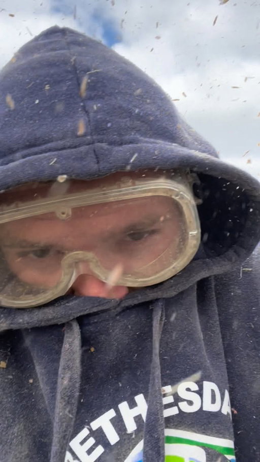 Getting pelted with corn silage while at the top of the silo