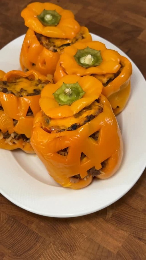 Jack-o-lanterns, but make them peppers 🎃🫑 @missbakersbites 

RECIPE 👇

Ingredients
●  5 orange bell peppers
●  1 tbs olive oil
●  1 medium onion, chopped
●  1 lb ground beef
●  1 tbs chili powder
●  1 tsp cumin
●  1/2 tsp oregano
●  1/2 tsp salt
●  1/4 tsp black pepper
●  2 cloves of garlic, minced
●  1/2 cup diced tomatoes
●  1/2 cup black beans
●  1 cup cooked rice
●  1/4 cup cilantro, chopped
●  1 cup Cheddar cheese, grated and divided

Directions

Preheat oven to 400 degrees. Using a pairing knife, cut a jack-o-lantern face into the side of each pepper. Cut around the top and remove any seeds and membrane from inside the pepper. Place peppers in a baking dish.
Heat oil in a large skillet and add onion and cook for 4-5 minutes. Add beef and once browned, add in the spices and add garlic. cook for 1 minute, or until fragrant.
Add diced tomatoes and beans and cook for 4-5 minutes then remove from heat and stir in the cooked rice, cilantro and half of the cheddar cheese.
Divide the mixture between the peppers and top each pepper with the remaining cheese.
Add a small amount of water to the bottom of the dish, cover with foil and bake for 40-50 minutes or until the peppers are soft. Remove the foil and bake for another 10 minutes.
Remove from the oven and allow to cool for 5-10 minutes before enjoying!