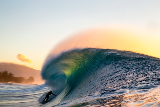 Shutter speed. 

Slowing things down in camera.  These range from 1/10s- 1/30s to achieve this looks.  Treading water.  Trick here is hold still and let the camera and wave do the work.  Having the background, clouds and subject in focus is key visually. 

No right or wrong with these, it’s open to your interpretation and style of shooting.