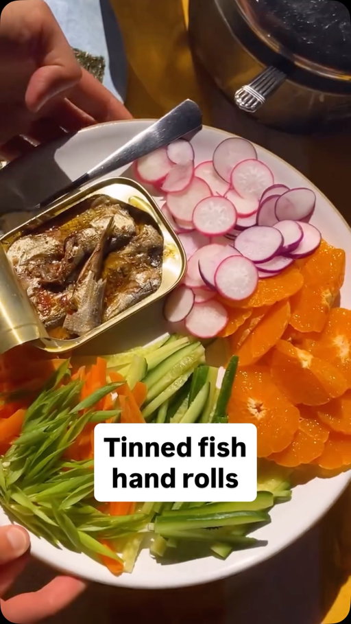 Here’s how to make @itsalislagle’s Tinned Fish Hand Rolls:

• 1½ cups sushi rice, rinsed well
• ¼ cup seasoned rice vinegar
• 1 tablespoon finely chopped ginger
• 4 roasted sushi nori sheets, quartered
• 4 tins of fish (about 4 ounces each), such as mackerel or sardines
• Any combination of sliced cucumbers, radishes, baby carrots, clementines and scallions
• Soy sauce or ponzu, for serving

In a medium saucepan, bring the rice and 2 cups of water to a boil. Cover, reduce heat to low and cook until tender, 18 to 20 minutes. Remove from heat and let sit, covered, for 10 minutes. (This is a good time to slice your toppings.)

When the rice is ready, drizzle with vinegar and top with ginger. Stir with a spoon to combine. (The rice, as well as the sliced toppings, can be transferred to airtight containers, covered with damp towels and refrigerated for up to 3 days. Bring the rice to room temperature before eating, or warm in the microwave.)

To build hand rolls, top nori with some rice, fish and any of the raw toppings. Drizzle with soy sauce or ponzu, wrap and enjoy.