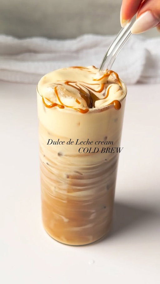 Dulce de Leche Cream Cold brew ✨

Ingredients:
* Ice
* Cold brew coffee
* Vanilla syrup (1-2 tbsp)

Dulce de Leche cold foam:
* 3 tbsp heavy cream
* 2 tbsp milk
* 1 tbsp dulce de leche sauce
* Topping: Dulce de leche sauce (for drizzling on top)
Instructions:
1. Fill a glass with ice and pour cold brew over it.
2. Stir in the vanilla syrup.
3. For the Dulce de Leche cold foam, whisk together heavy cream, milk, and dulce de leche sauce until creamy but still pourable.
4. Pour the Dulce de Leche cold foam over the cold brew.
5. Drizzle the top with a generous amount of dulce de leche sauce for added sweetness and richness.
6. Stir and enjoy!

#coldbrewcoffee #dulcedeleche #icedcoffeerecipe #icedlatte #coffeegirl #reelsinstragram #instantcoffee #reelsvíral #icedlatte #reelsinstagaram