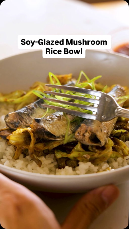 Here’s how to make @ifahmed’s Soy-Glazed Mushroom Rice Bowl:

• 5 teaspoons olive oil, divided
• ½ pound cremini mushrooms, sliced
• 1 medium (1½-pound) Napa or green cabbage, cored and chopped
• 3 large garlic cloves, smashed
• 3 tablespoons soy sauce
• 1½ teaspoons chile-garlic sauce (preferably Huy Fong), plus more for serving if desired
• 1 teaspoon toasted sesame oil
• Cooked white rice, for serving
• 3 (4-ounce) cans boneless sardines in oil (skin-on or skinless), optional
• Thinly sliced scallions, for serving

In a large cast-iron skillet over medium-high heat, warm up 3 teaspoons of olive oil. Once oil is loose and shimmering, about 1 minute, add the mushrooms and stir sparingly, leaving the mushrooms largely undisturbed. Cook until the mushrooms have softened and reduced down slightly in size, about 5 minutes.

Stir in the chopped cabbage and the remaining 2 teaspoons of olive oil, cover and cook, stirring occasionally. After 2 to 3 minutes, lower the heat to medium and stir in the garlic, soy sauce, chile-garlic sauce and sesame oil. Cover and cook for another 15 minutes, stirring as needed, until the cabbage is almost caramelized.

Serve the cabbage-mushroom mixture over rice. Top with sardines, if you like, and scallions. Serve with additional chile-garlic sauce. Enjoy immediately or store in the fridge in an airtight container for 2 to 3 days.