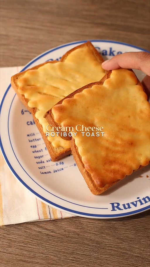 🧀🍞 Cream Cheese Toast
Rotiboy / Roti’O / Papparoti Style

📝 Recipe

80g • Cream Cheese (room temperature)
100g • Icing Sugar / Caster Sugar
1 Egg
70g • All Purpose Flour
2 Slices • Thick Bread

*note: you can make up to 4-5 slices of bread with the batter

Instructions:

• Cream Cheese Batter
- add cream cheese and sugar in a mixing bowl, then mix them with spatula until everything is mixed
- crack open one egg and whisk using whisker
- add flour and mix again using spatula
- transfer the batter into a pipping bag

• Baking; Bread + Cream Cheese Batter
- pipe the cream cheese batter onto the bread
- bake the bread in the air fryer / oven at 150℃ for 15 minutes / 180℃ for 10 minutes

//

Easy recipe at home with IC! 👩‍🍳🍞

I’m back with my Rotiboy recipe. I have made the coffee, matcha, chocolate, red velvet flavors— now I made one with cream cheese flavor! This one is the best if you dip it in your drink, be it coffee or matcha. 🤤

—

#rotiboy #creamcheese #toast #homecafe #asmr #homecafeindonesia #homebaking #breadrecipe #easyrecipes