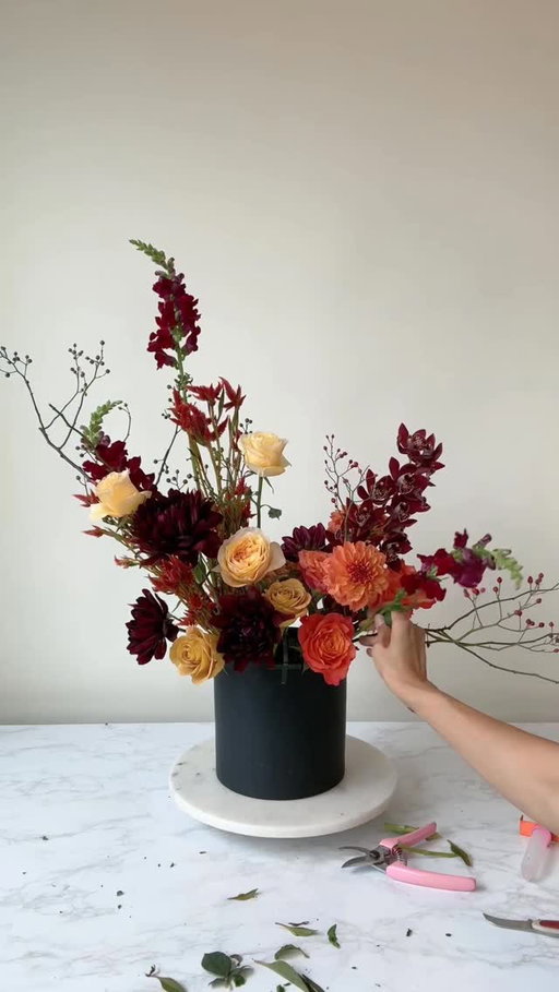 Fall flower therapy 💆🏻‍♀️
It’s time to get yourself flowers, put on music, and play. Your soul will thank you ❤️ 

Mechanics used: chicken wire to hold the stems + tape to hold down the chicken wire. Why? Your arrangement might start getting heavy and pull out. 

Flowers used: dahlias, roses, celosia, coxcomb, snap dragon, calla, cymbidium orchid, red berry branch, copper beech. 

Flower food: a splash of lime soda + a few drops of bleach 

Follow for more flower arranging 
#dahlia #flowerstagram #floristofinstagram #flowerarrangement #flowers #rachelchofloral