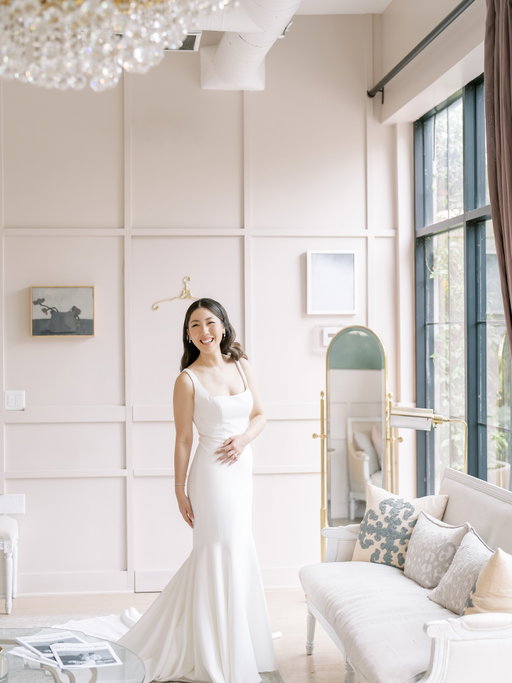wedding dress & bridal bouquet details 💐🤍

I wanted my dress to be something simple, classic, and timeless! My non-negotiables were no lace, crepe material, and a square neckline. It’s so crazy how wedding dress styles come and go—and how you have to choose your forever dress almost a year in advance! I also opted for a very simple veil with no lace. I was actually torn between this dress and a bigger, more ball gown–style dress, but I ultimately chose one that fit the overall vibe of my venue better.

My wedding bouquet incorporated soft pink tones to create a whimsical, romantic vibe, and I had to include orchids in both my bouquet and my husband’s tux. It was an ode to my family roots in Singapore, representing the national flower but, of course, in an all-white color palette.

Dress detail:@jennyyoonyc @styledbytc 
Florals: @eveni.floral 
PC: @donnalamphotography