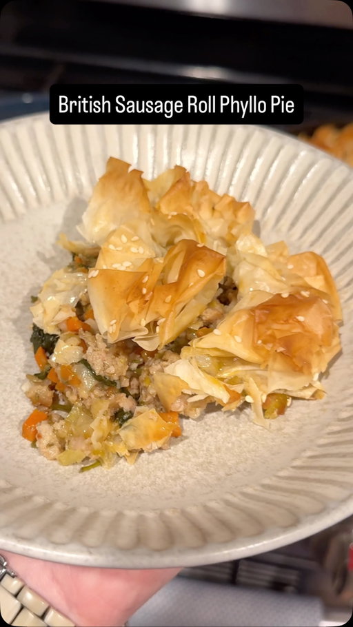I’m so glad my brain told me to bring this recipe to life. Holy shit was it good! 😂 Basically it’s a savory sausage roll pie. 💯

Full recipe below!

✨For the Sausage✨
2 lbs Italian pork sausage
3 Tbsp Dijon mustard
2 Tbsp chopped fresh sage
2 Tbsp chopped fresh rosemary
2 tsp fresh lemon zest
1 tsp ground mace
1 tsp kosher salt
½ tsp black pepper

✨Remaining Filling Ingredients✨
2 Tbsp olive oil
1 large leek, thinly sliced
1 sweet onion, halved and thinly sliced
2 large carrots, diced
½ cup dry white wine
1 Tbsp flour
1 bag fresh baby spinach
Kosher salt
Freshly ground black pepper

✨For the Phyllo✨
~6 sheets of phyllo dough, defrosted, broken into squares
3 Tbsp unsalted butter, melted
2-3 tsp sesame seeds

1️⃣ MIX THE FILLING. Preheat oven to 400°F (205°C). In a large bowl, mix together sausage, Dijon mustard, herbs, and spices until very well blended.
2️⃣ COOK THE VEGGIES. Heat 2 Tbsp olive oil in a large pan over medium heat, then add sliced leeks, onion, and carrots. Season lightly with salt and pepper, then cook, stirring often, until softened, about 4-6 minutes. Use a spatula to clear the center of the pan, pushing the edges to the sides.
3️⃣ ADD SAUSAGE. Raise the heat to medium-high, add all of the sausage to the pan, then cook it, alongside the veggies, until browned on all sides and mostly cooked through.
4️⃣ DEGLAZE WITH WINE. Pour in ½ cup white wine and use a spatula to scrape any browned bits off the bottom. Allow the wine room to reduce by half, then sprinkle in the flour. Stir well.
5️⃣ ADD SPINACH. Add an entire bag of baby spinach, cook until wilted, stirring occasionally, then turn off the heat. Taste and adjust seasoning as needed.
6️⃣ TOP WITH PHYLLO. Cut or break a slice of defrosted phyllo into small pieces (roughly 3-inch squares), then crumble and place on top of the filling with the edges facing up. Repeat until the entire pan is filled with phyllo. 
7️⃣ BAKE. Brush melted butter lightly all over the phyllo, then sprinkle with sesame seeds. Bake for about 30-40 minutes, until the phyllo is golden brown and impossibly crispy. Dig in while hot!

#dinneridea #sausagerolls #phyllo #easydinner #comfortfood