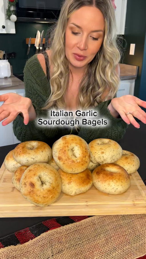 🧄 Roasted Garlic Italian Sourdough Bagels

This was one of those recipes I didn’t plan on sharing, but with so many new faces around here and Thanksgiving right around the corner, it just felt like the perfect time to drop it. There’s something about the smell of roasted garlic and sourdough that just feels like the holidays.

Bagel Dough
• 332 g active sourdough starter
• 464 g water
• 1112 g bread flour
• 55.5 g raw cane sugar
• 55.5 g pure maple syrup
• 22.25 g salt
• 10 g Italian seasoning
• 66 g roasted garlic (made below)

Roasted Garlic (make first + cool completely)
• 66 g garlic (about 3 whole heads)
• Olive oil (enough to lightly coat)
• Pinch of salt

Method:
	1.	Slice the tops off your garlic heads, drizzle with olive oil, and sprinkle with salt.
	2.	Wrap in foil and roast at 425°F (218°C) for 30–45 minutes until golden, soft, and caramelized.
	3.	Let cool completely, then squeeze out the cloves and mash lightly before adding to dough.

Bagel Method
	1.	Combine starter, water, maple syrup, sugar, and salt in your mixer bowl.
	2.	Add flour and mix on low until shaggy.
	3.	Add in your roasted garlic and Italian seasoning, then mix until smooth and elastic (about 10 minutes).
	4.	Rest 1 hour, then shape into a tight ball.
	5.	Cover and let bulk ferment until doubled (about 4–6 h room temp or overnight if your house sits around 70°F).

Shape + Bake
	1.	Divide into 12 pieces (about 170 g each) and shape into balls.
	2.	Cover and let rest 20 minutes.
	3.	Poke a hole through each center and stretch into bagels.
	4.	Place in a covered container for their final rise until puffy and jiggly.
	5.	Boil each bagel 30 sec per side in water with 50 g honey.
	6.	Bake at 425°F (218°C) for 15–18 minutes until golden and glossy.
	7.	Cool at least 1 hour before slicing for that perfect chewy texture.

#sourdoughbagels #garlicbagels #italiandough #savoryrecipes #sourdoughrecipe