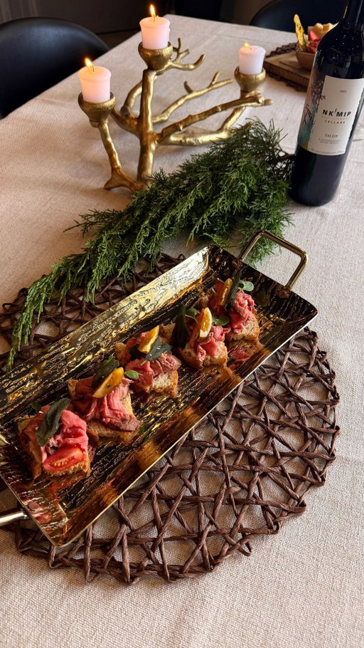 Sage is a teaching plant. A protector. A reminder.
⠀
In Syilx tradition, sage plays both ceremonial and culinary roles — grounding us, cleansing the spirit, and bringing intention to what we prepare and share.
⠀
This next recipe in our 𝑮𝒂𝒕𝒉𝒆𝒓 series is rooted in that spirit: Sage Roast Crostini — spice-rubbed roast beef, seasoned cream, and a touch of sage on crisp crostini.

Created by Nk’Mip Cellars Winemaker Justin Hall and Sweetgrass Kitchen Chef Sean, this recipe brings culture, flavour, and community together in one bite.

✨ Best paired with our 2022 Storytellers Talon, a rich, blend that holds its own with spice, structure, and warmth. Double Gold winner at the All Canadian Wine Championships and Gold at the WineAlign National Wine Awards of Canada.

🥩  Sage Roast Crostini
•  12 crostini or toasted baguette slices
• 12 slices roast beef (homemade or deli)
• ¼ cup mayo or whipped cream cheese
• Fresh sage leaves for garnish

🌿  Spice Rub
• ½ tbsp smoked paprika
• ½ tbsp fine sea salt
• ½ tbsp onion powder
• 1 tsp garlic powder
• 1 tsp mustard powder
• 1 tsp coriander
• ½ tsp white pepper
• 1 tsp brown sugar
• ½ tsp dried sage

Assembly:
Mix a pinch of the rub into mayo or cream cheese.
Spread onto each crostini.
Fold and place a slice of roast beef on top.
Garnish with fresh or crispy sage.

Even the smallest bite can carry a story, a sense of ceremony, and the spirit of gathering.

Sage in Indigenous food, Gather recipe series, roast beef crostini, wine pairing with beef, Winemaker’s Talon pairing, Syrah blend BC wine, Nk’Mip holiday recipes, Indigenous-owned winery