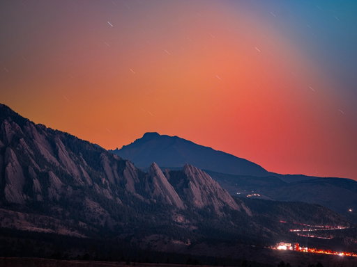 Photos by Keith Ladzinski @ladzinski | Last night the aurora borealis filled the skies throughout the Northern Hemisphere, powered by a G4-level geomagnetic storm, one of the strongest our planet has experienced in years. A chain of solar eruptions (coronal mass ejections) from sunspot region 4274 hurled plasma toward Earth, compressing our magnetic field and igniting brilliant auroras visible far beyond the Arctic Circle. The colors are dictated by gases; oxygen produces green at 100 miles (160 kilometers) high, while nitrogen produces pink and purple edges. I shot these photos in Boulder, Colorado, as the northern lights danced over the iconic Flatirons and Longs Peak, the state’s northernmost 14,000-foot (4,267-meter) peak. If you look closely, you can see headlamps from rock climbers as they made their way up the Third Flatiron. It must have been an incredible way to experience this celestial event.