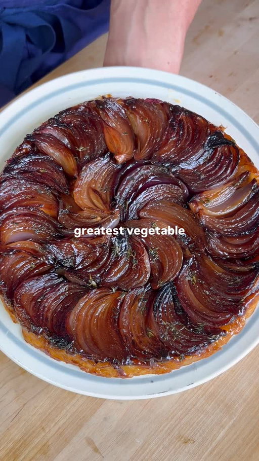How to Make an Onion Tarte Tatin 🧅🧅

RECIPE ⬇️

NOTE: this is for a 9" cast iron pan - measurements for a bigger/smaller pan will need to be scaled.

INGREDIENTS: 
6 small red onions 
8-10 sprigs of thyme 
1/4 lb of butter
2 tbsp granulated sugar
1 tbsp sherry vinegar
1 10" x 10" sheet puff pastry
1/2 bunch chives
1 lemon
250mL crème fraîche
1/4 bunch parsley leaves
Salt and pepper to taste
Fleur de sel 

INSTRUCTIONS
1. Pre-heat your oven to 400 degrees F.
2. Remove the skin from your red onions, and trim the root to remove just the dried/frilly part of the root on the exterior of the onion, keeping the interior of the root intact (it will help keep your onions together, and will eventually fully soften). Divide each onion into 6 equal wedges.
3. In your cast iron skillet, or another heavy-bottom pan, heat 3 tbsp of butter over medium-high heat. Once it begins to foam, add your onions with one of the cut sides down. Season generously with salt. Lower the heat to medium, and allow the onions to cook until nicely golden brown. Then flip the onions onto the other cut side, and cook until that side is brown as well. Remove your onions from the pan and transfer to a tray or plate. 
4. If you used your cast iron pan to sear your onions, quickly rinse it clean and wipe it dry. Once the pan has cooled down, spread your sugar around the pan in an even layer. Drizzle your sherry vinegar around the sugar. Place your pan over medium heat, and allow the sugar to caramelized (do not stir - just tilt your pan if needed to allow the sugar to caramelize evenly). When the sugar is light brown in colour (almost all the moisture will appear to have evaporated, and the caramel will be a syrupy consistency), turn the heat to low. Add 3 tbsp butter to the pan, and stir over low heat for 90sec-2min, trying to keep the glaze as emulsified as possible. 
5. Turn off the heat and set your pan to the side momentarily. Pick the leaves from your thyme, and sprinkle it around your caramel. CAREFULLY place your onions around the pan in a spiral, being sure to keep the onions as close together as possible. 

RECIPE CONTINUES IN THE COMMENTS ⬇️

#onion #tartetatin #homecooking #recipe