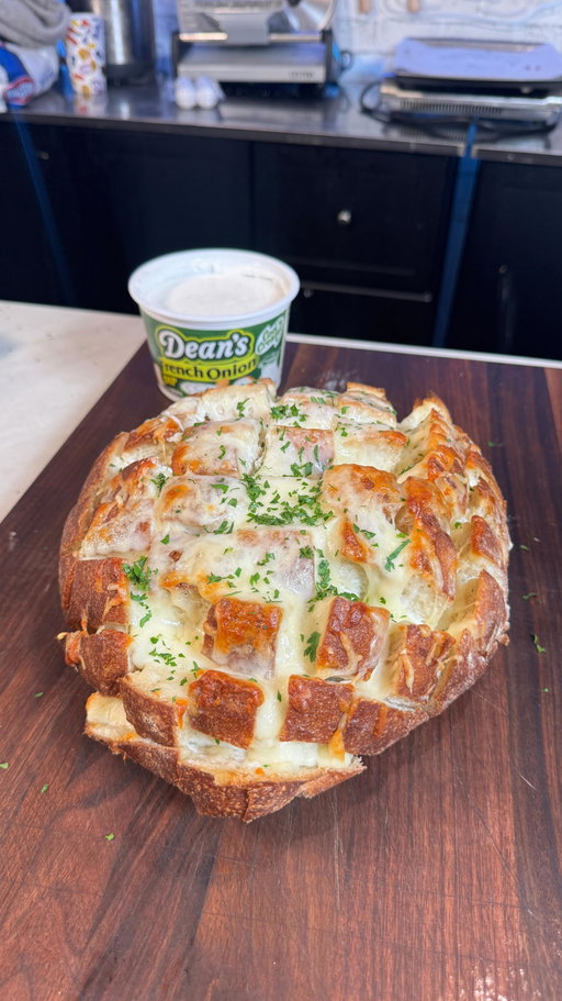 French Onion Dip Pull Apart Bread featuring @deansdip Recipe Below
#DipIntoTheSeasonWithDeans

INGREDIENTS
1 large circular loaf
10 pieces of string cheese
1/2 cup grated mozzarella
1/2 cup grated Gruyere cheese
1 container of Dean’s French Onion Dip
1/4 cup chopped parsley for garnish