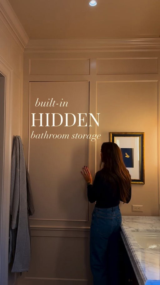 There’s a secret hiding in our bathroom walls… 

We originally planned for medicine cabinets behind the vanity mirrors, but then thought… why not turn the whole wall into storage? The push-open doors disguised within the moulding gave us all the extra bathroom storage we needed while giving the space a clean, minimal look.