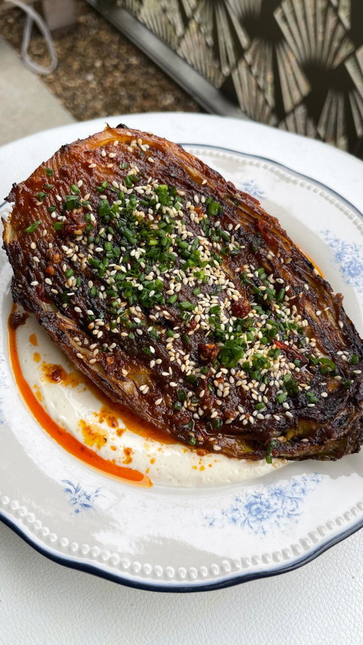 All aboard the umami train….it’s time for the best cabbage you’ll ever have, smothered in an addictive miso and caramelised onion butter ✨

Cabbages are in season all year round but when winter hits there’s something about a roasted charred cabbage that really gets my heart racing. This dish is ridiculously easy to make, you just have to commit to getting a really good char on those cabbages. Promise it takes it from a 10 to a solid 15/10, easily. 

RECIPE

Caramelised onions:
1 onion, thinly sliced
1 tbsp vegan butter
1 tbsp olive oil
Salt

1 sweetheart cabbage, sliced lengthwise
2 tbsp vegan butter 

Miso butter:
60g vegan butter
2 tbsp brown miso
1 tsp white miso
1 tsp rice wine vinegar
2 tsp agave
¼ tsp ginger, grated
Caramelised onions

Tofu sauce (blend everything together until smooth):
½ pack silken tofu
Pinch of salt
Lime juice, to taste

Toasted sesame seeds
Chopped chives
Chilli oil

1. Preheat the oven to 180 degrees fan/200c oven. Heat a frying pan over a medium low heat for the caramelised onions. Add the butter and olive oil followed by the onions and a pinch of salt. Fry the onions for about 30 minutes until they turn dark brown and jammy, stirring frequently (and adding a splash of water as needed) to avoid them burning. 

2. Whilst the onions caramelise, heat a large frying pan (that's also oven safe). Melt the butter and olive oil then place the cabbage halves cut side down into the pan and fry until evenly charred, applying pressure on top of each wedge to help them along.

3. Once properly charred (don't be shy), place the pan with the cabbages into the oven and roast for 25 minutes until softened. 

4. When the onions have become jammy, remove from the pan to allow them to cool for a few minutes before placing in a blender with the other ingredients for the miso butter. Whiz everything together until you get a smooth paste. 

#cabbagerecipe #misobutter #vegandinner #veganrecipes