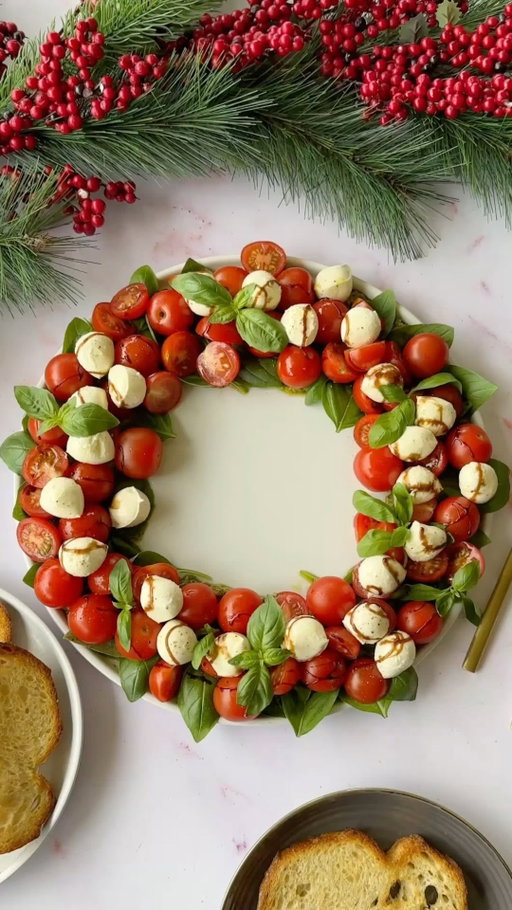 Caprese Wreath Salad 🍅🌿🎄
(Via: @lizthedietitian)

A festive twist on a classic favorite — this Caprese Wreath is fresh, bright, and stunning on any holiday table. Ready in under 10 minutes, it’s the perfect mix of flavor and presentation! Serve it as a light starter or with toasted bread for a beautiful Christmas appetizer ✨

Ingredients
* ½ jar pesto (store-bought or homemade)
* 1 bunch fresh basil (bright, large leaves)
* 500 g cherry or grape tomatoes
* 220 g baby bocconcini (fresh mozzarella balls)
* Extra virgin olive oil
* Balsamic glaze (thick, caramelized type)
* Toasted bread, to serve (optional)

Instructions
1️⃣ On a large round platter, spread a ring of pesto to form the wreath base. 2️⃣ Arrange basil leaves over the pesto. 3️⃣ Slice half the cherry tomatoes, leaving the rest whole, and layer them on top. 4️⃣ Drain and pat dry the bocconcini, then arrange them evenly around the wreath. 5️⃣ Drizzle with olive oil and balsamic glaze. Season with salt and pepper. 6️⃣ Garnish with a few small basil leaves for a fresh, festive touch. 7️⃣ Serve immediately or chill briefly before serving.
This fresh, colorful salad brings the holiday cheer to your table — simple, elegant, and irresistibly delicious! 🍅🎄

💚 Follow @Calories.Tips for more easy festive recipes, healthy appetizers & holiday table inspiration!