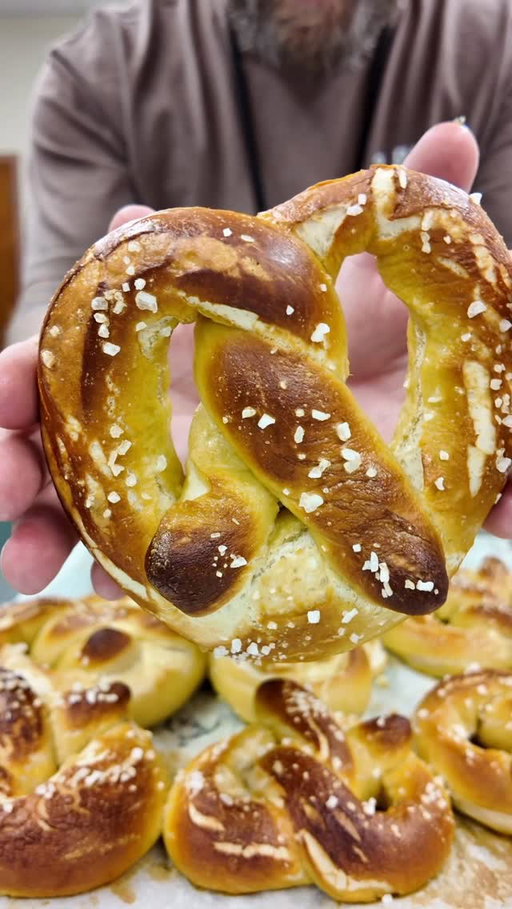 Soft, golden, buttery… and SUPER fun to make! 

SAVE and SHARE this one! 

This video is during my class so we half the recipe due to budget/portion requirements! Full and complete recipe is below! 

Ingredients:
• 1 + ½ tsp yeast
• ¾ cup warm water (115°F) 💧
• 1 Tbsp brown sugar 🍯
• ½ tsp salt 🧂
• 1 Tbsp melted butter 🧈
• 2 cups flour (extra for kneading) 🌾
• 2 cups water 💧
• 1/8 cup baking soda ⚗️
• Butter or toppings for after 🧈✨

⸻

Directions:

1️⃣ Mix warm water, yeast & brown sugar in a bowl until dissolved.
2️⃣ Add salt + melted butter.
3️⃣ Add 1 cup flour and mix for 2 minutes.
4️⃣ Add the 2nd cup of flour and mix with a rubber scraper.
5️⃣ Turn onto a lightly floured surface and knead until smooth & elastic.
6️⃣ Cut into 6 pieces ➜ makes 3 pretzels.
7️⃣ Shape each piece into a pretzel and place on a baking sheet.
8️⃣ Freeze for 30 minutes to help them hold their shape. ❄️
9️⃣ Preheat oven to 475°F.
🔟 Bring 2 cups water to a boil and add baking soda.
1️⃣1️⃣ Boil pretzels (3 at a time) for 15 seconds.
1️⃣2️⃣ Place on a lightly greased baking sheet.
1️⃣3️⃣ Bake at 475°F for 8–10 minutes until golden.
1️⃣4️⃣ Brush with melted butter + any toppings you love! 🧈🎉

#groarkboysbbq #softpretzels #cooking