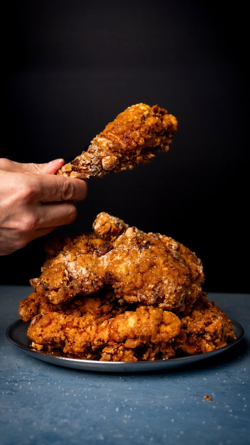 Ayam Goreng 🍗

Ingredients
1.8kg (4lbs) whole chicken
sea salt, to season
1 tsp coriander seeds
1 tsp fennel seeds
1 tsp cumin seeds
½ tsp black peppercorns
3 dried chillies, chopped 
4 shallots, sliced
6 cloves garlic, sliced
4cm piece fresh ginger, chopped
4cm piece galangal, chopped
1 lemongrass, white part only, chopped
2cm fresh turmeric, chopped 
2 lime leaves, shredded
1 tsp curry powder
125ml (½ cup) water
1 egg
150g (1 cup) cornflour (cornstarch)
peanut oil (or other neutral oil) for deep frying

Method
Step 1: Prep the chicken
Break the chicken down into 10 pieces by removing the legs and wings, splitting the legs into drumstick and thigh, removing the breasts and halving each into 2 pieces. Season generously with salt and set aside on a tray. 
Step 2: Make the marinade
Place the coriander, fennel, cumin, peppercorns and chillies in a dry frying pan over medium high heat. Toast the spices for 1 minute until fragrant. 
Transfer to a mortar and pestle and grind to a powder. 
Place the shallots, garlic, ginger, galangal, turmeric, lemongrass, lime leaves and curry powder in a small food processor. Add the spice powder and season with some salt. Add the water and process until a smooth paste forms, scraping down the sides a few times. 
Place the marinade in a large bowl, then add the chicken and toss very well to completely coat the chicken pieces. Cover and refrigerate for 1 hour, up to overnight. 
Step 3: Cook the chicken
Place the cornflour in a medium bowl. Mix the egg through the marinated chicken until completely combined. 
Toss each piece of chicken in the cornflour, trying to keep as much of the marinade still on the chicken. Place the pieces on a wire rack over a tray. 
Heat enough oil for deep frying in a deep saucepan to 180°C (355°F). 
Cook the chicken in batches for 10-12 minutes, until golden, crisp and cooked through to 65°C (150°F). Drain on a wire rack.
Serve hot with a sprinkle of salt and enjoy!
#chicken #fried #food #recipe