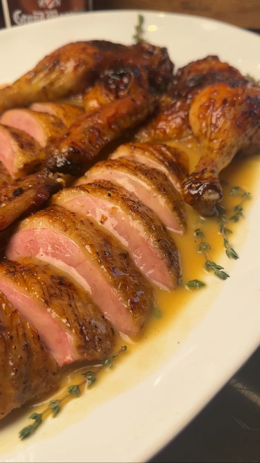 GLAZED ROAST DUCK / ORANGE SAUCE 🍊🦆✨

@cud_cooks x @robertwelchuk AD

Crisp skin, pink breast, slow-cooked legs, and a glossy spiced glaze - finished with a rich orange sauce flambéed with Grand Marnier. A stunning winter centrepiece.

RECIPE ⬇️

Salt a 2.2kg whole duck all over and leave uncovered in the fridge overnight. Break it down into the legs, wing tips, and crown (two breasts together), and score the breast skin (don’t cut the meat).

Roast the legs & wing tips at 150°C for 1 hour until tender. Whilst they are cooking, make the glaze: In a pan combine 1 cinnamon stick, 2 star anise, 4cm sliced ginger, 2 tbsp brown sugar, 2 tbsp honey, zest of 1 orange, 2 tbsp white wine vinegar, 2 tbsp soy sauce, 200ml orange juice. Bring to a boil and reduce until thick, glossy, and able to coat a spoon.

Remove the legs and increase the oven to 210°C. Add legs, wing tips and crown to a 316 Series Low Casserole pan. Brush with glaze → roast 10 mins, glaze again → roast 10 mins, glaze again → roast final 10 mins. Keep an eye on the breast and remove once it hits 50°C internal (rising to ~55°C as it rests), and rest uncovered in a warm place (e.g. a warming oven)/

Whilst resting, make the orange sauce. In a pan, melt 30g butter and soften 2 sprig rosemary and 2 sprigs thyme. Add 150ml Grand Marnier and flambée. Add 500ml chicken stock, 1 tbsp honey, 1 tsp Dijon mustard, 150ml orange juice, and simmer for 15 minutes. Strain, and finish with butter and season with salt & pepper. Add a cornflour slurry (1 tsp cornflour + 1 tbsp water to start) - add more as needed. Sauce should be glossy and lightly thickened, not gloopy. Stir in 1–2 oranges, segmented.

#roast #duck #oranges #recipe #cooking #christmas #dinner

Carve the rested duck and spoon over the orange sauce and finish with extra orange segments.