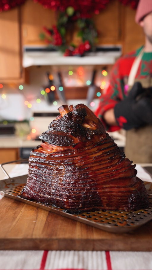 Glazed Holiday Ham

Recipe:
-Make the pre-glaze by blending 1 cup honey, 1 stick butter, and 3 tbsp dijon mustard.
-Cover the spiral ham inside and out with the pre-glaze.
-Place on the grill at 325F indirect for 2 hours (or until it looks the way you want).
-Make the post-glaze by simmering 2 cups pineapple juice, 1/2 cup brown sugar, 3 tbsp brown mustard, 3 tbsp honey, and 1 tbsp BBQ rub until it thickens.
-Allow the glaze to cool, then paint it on the ham near the end, and keep it on the grill for at least 15 minutes to let the glaze tack up.
-Rest for 15 minutes then enjoy!
