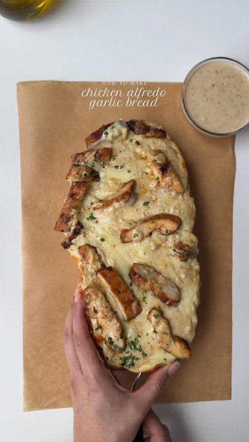 Chicken Alfredo garlic bread🥖 

Ingredients 

For the chicken 

1 lb boneless skinless chicken breast, halved lengthwise and pounded to an even thickness
Salt to taste
1 tbsp smoked paprika powder 
1 tbsp garlic powder 
1 tsp black pepper 
1 tsp onion powder 
2 tbsp clarified butter or oil for cooking 

For the Alfredo sauce:

2 tbsp fresh garlic ,  finely minced
2 tbsp butter 
1 cup unsweetened heavy whipping cream 
Salt to taste
1 tsp black pepper 
1/2 cup freshly grated Parmesan cheese 

For the garlic butter compound:

1/2 cup unsalted butter, softened 
1 tbsp fresh garlic, finely minced 
1 tbsp fresh parsley, finely chopped 

To assemble;

1 loaf of Italian bread 
1 cup mozzarella cheese 

Method:

Pre heat oven to 350 F.

Pat dry the chicken Season the chicken with salt, pepper, paprika, garlic powder, onion powder on both sides. 

In a pan heat clarified butter or oil on medium heat. Once the butter is melted add seasoned chicken and cook for 4-5 min per side or until the internal temperature reaches 165 F.
Remove chicken from the pan slice it and set aside.

In another pan add butter on medium low heat, once butter is melted add garlic and sauté until fragrant. Add heavy whipping cream . Bring the mixture to boil , gradually add Parmesan cheese. Season with salt to taste and black pepper. Cook on medium low heat until sauce thickens 

Make garlic butter compound by mixing softened butter, garlic and parsley in a bowl add some salt and mix well to combine.

Cut the loaf in half lengthwise and spread 2-3 tbsp garlic butter compound on it. Add the Alfredo sauce. Add mozzarella cheese and top it with slices chicken . Lastly add more Alfredo sauce on top and some parsley.

Place on a baking sheet and bake for 20-25 min or until the bread is crispy and the cheese is melted and golden.

Serve warm either with leftover Alfredo sauce and enjoy.

#chickenalfredo #garlicbread #recipe