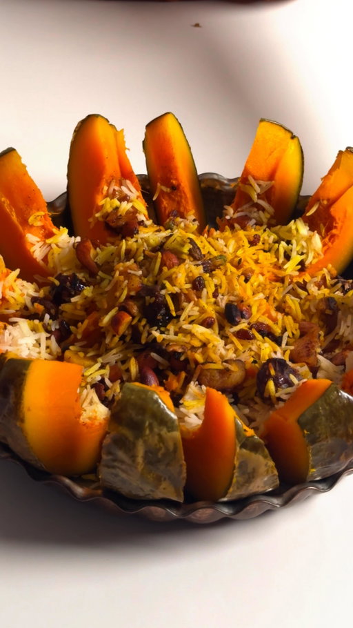 Ghapama (Stuffed Pumpkin) a traditional Armenian delicacy made by the Armenian community of Iran 🎄

#Christmas #averytastychristmas 

Ingredients:
Medium sized pumpkin
Handful of walnuts, pistachios, almonds
Handful of pitted dates, dried apricot and raisins
1 tsp cinnamon
1 tsp nutmeg
1 tbsp salt
1 tbsp agave syrup/maple syrup/honey
1/6 tsp saffron dissolved in
1/4 cup boiling water
2 cups basmati rice

Method:
Cut the top off the pumpkin and remove the seeds from the inside. Brush inside and outside with oil.
Half cook the rice - boil 2 cups of rice with 1 tbsp salt and water until half cooked. Drain and wash with cold water. Set aside.Roughly chop the nuts and dried fruits.
Sautee in some oil for a few minutes. Add cinnamon, nutmeg and syrup.Layer the rice, and toasted nut mixture inside the pumpkin.
For every layer add a sprinkle of cinnamon and nutmeg, and some saffron water. Once the pumpkin is full, add the lid back on.Bake at 180 for an hour or until the pumpkin is cooked through