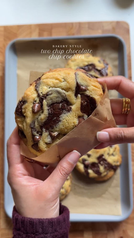 Yield: Approximately 8-10 large cookies

Ingredients:

2 1/4 cups (313 g) all-purpose flour
1 ½ teaspoons baking powder
1 teaspoon baking soda
1 teaspoon cornstarch
3/4 cup (150g) dark brown sugar
1/4 cup (50g) granulated sugar
2 cold eggs
2 teaspoons vanilla extract
1 cup (225g) unsalted butter, slightly softened
Pinch of salt
1 1/2 cups (250g) semi-sweet chocolate chips
1 cup (200g) dark chocolate chips

Instructions:

Preheat oven to 350°F (180°C). Line a baking sheet with parchment paper.
Whisk together flour, baking powder, baking soda, and cornstarch in a medium bowl. Set aside.

Cream together brown sugar, granulated sugar, and butter in a large bowl until light and fluffy.

Beat in eggs one at a time, followed by vanilla extract, for 3-4 minutes until the batter turns pale and the sugar is well incorporated.

Gradually mix in dry ingredients until just combined, being careful not to overmix.

Stir in chocolate chips.

Scoop 2 tablespoon-sized balls of dough onto the prepared baking sheet. Leave the dough balls slightly rough and stacked, with a rustic texture. Place 4 cookies on each pan, leaving 4 inches of space between each one. Top with extra chocolate chips.
Bake for 13-16 minutes on middle rack or until edges are lightly golden brown.

Remove from oven and let cool on the baking sheet for 5 minutes before transferring to a wire rack to cool completely.

#cookies #chocolatechip #baking