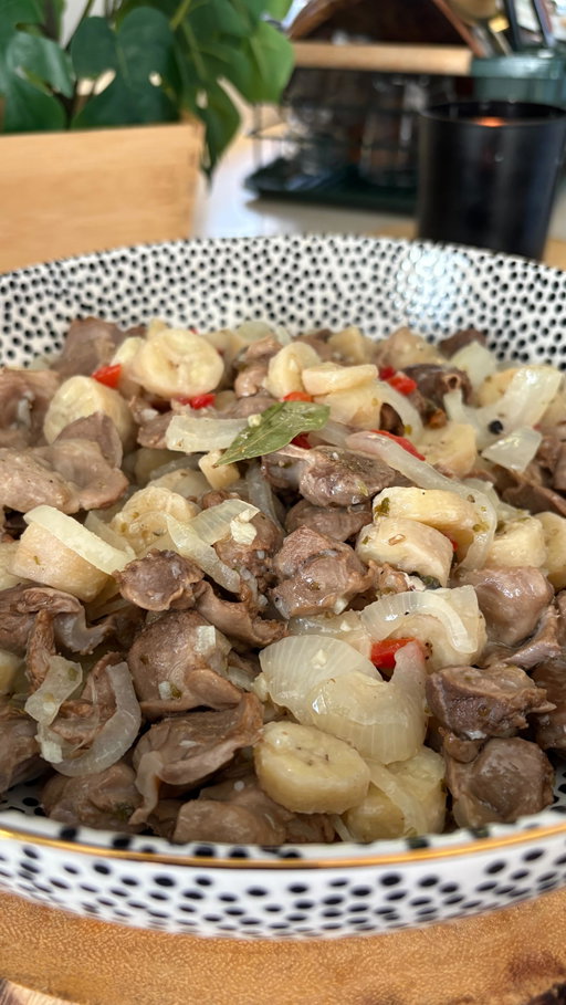 Mollejas En Escabeche Recipe 🇵🇷

* 1 1/2lbs chicken gizzards
* 6-8 green unripe bananas
* Bay leaves 
* 1 tbsp milk
* 1 large or 2 small yellow onion sliced
* 4 garlic cloves minced
* Whole pimento pepper diced
* 1 tsp whole peppercorn
* 1 tsp oregano leaves
* 1/2c oil
* 1/2c white vinegar
* Adobo to taste 

1. Rinse the gizzard with vinegar, salt, and cold water 
2. Bring the gizzard to boil, about 12c of water, add few bay leaves and adobo to taste. 
3. Once brought to a boil, cover to soft boil, to medium low heat. Until tender for about an hour and a half. 
4. Once you have half an hour to go, you can start boiling the green bananas, add milk to prevent from coloring and adobo to taste. Boil for 20-25 minutes until tender, then remove peel, and thinly sliced bananas.
5. Prep your ingredients above, onions, garlic, pimento, and spices. 
6. Once gizzard and green bananas done, go proceed finish the dish. On medium heat add oil, onions, and garlic cook until fragrant, add spices and vinegar, cook for few minutes, add bananas and gizzard, add 2 bay leaves and adobo to your taste. 
7. Mix well and cook additional 5-10 minutes and it's ready to serve.