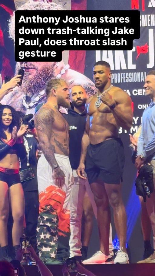 Anthony Joshua stares down trash-talking Jake Paul, does throat slash gesture @netflixsports @mostvaluablepromotions