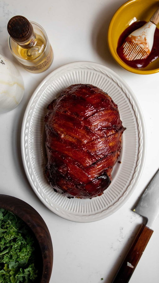 This bacon-wrapped meatloaf means business 🙂‍↕️🥓 @chef.souschef 

RECIPE 

Ingredients:
●  1 tbsp olive oil
●  1 small leek, white portion only, thinly sliced
●  2 cloves garlic, chopped
●  1 cup bread crumbs
●  ⅔ cup milk
●  1 egg, beaten
●  2 tsp Worcestershire
●  2 lbs ground beef
●  1 tsp salt
●  1 tsp pepper
●  12 slices bacon

For the Glaze

●  ½ cup ketchup
●  ¼ cup maple syrup
●  1 tbsp bourbon
●  Salt and pepper

Directions:

Preheat the oven to 375°F.
Heat olive oil in a skillet over medium heat. Sauté the leeks and garlic for 5–7 minutes, until softened.
In a large mixing bowl, combine the bread crumbs and milk. Let sit for 5 minutes.
Add the cooked leeks and garlic, egg, Worcestershire, ground beef, salt, and pepper. Mix well using a wooden spoon or your hands.
Transfer the meat mixture to a baking sheet (or parchment-lined sheet pan) and shape into a loaf.
In a small bowl, whisk together ketchup, maple syrup, bourbon, salt, and pepper. Brush a layer of glaze over the entire meatloaf.
Lay the bacon slices over the top in a criss-cross or shingled pattern.
Bake for 60–75 minutes, brushing with more glaze at 45 minutes, then every 15 minutes after, until the meatloaf reaches an internal temperature of 160°F.
Rest for 10 minutes before slicing. Serve hot.