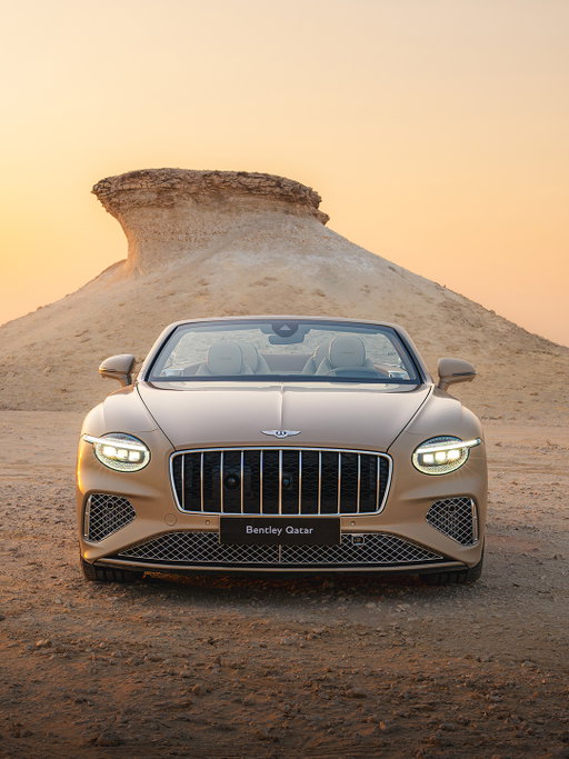 A one-of-one tribute to the jaw-dropping beauty of a Gulf sunset, meet the Bentley GTC Azure Mulliner Qatar Edition.​

​Painted in the bespoke colour formulation of Desert Sand, it's a honeyed hue that resonates in the rich golden light. The interior gets a non-traditional twist, thanks to the plaid cloth and embroidery cleverly tapered to reflect the sky as it lightens towards the horizon.​

​In the heat of a desert day, you need the shade of a roof. But as evening closes in and its temperature eases, what's better than to drop the multi-layer fabric from overhead, and travel through balming air and saturated colours? The Azure is already the most luxurious of the GTC specifications and localising it to this special place only adds to the experience.​

Discover more via the link in our bio.​

#Bentley #BentleyContinentalGTC

Continental GTC Azure (hybrid) WLTP drive cycle: Electrical consumption weighted, combined – 19.9 (kWh/100km). Fuel consumption combined with discharged battery – 26.6 (10.6) mpg (l/100km). Fuel consumption weighted, combined – 66 (4.3) mpg (l/100km). CO₂ emissions weighted, combined – 98 g/km. CO₂ class weighted, combined – C. CO₂ class with discharged battery – G.